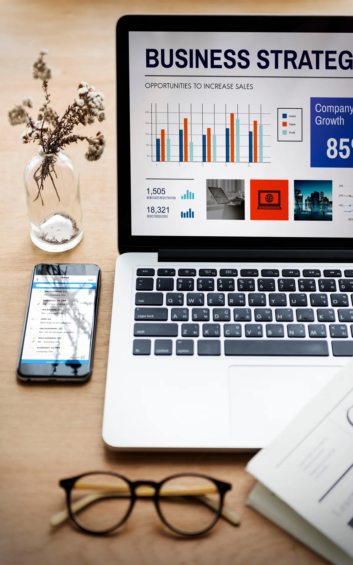 Marketing team analyzing business strategy data and website performance reports on laptop and tablet.